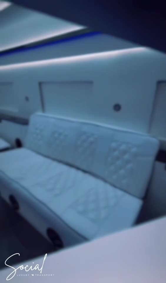 Ambient blue glow along the white leather seating