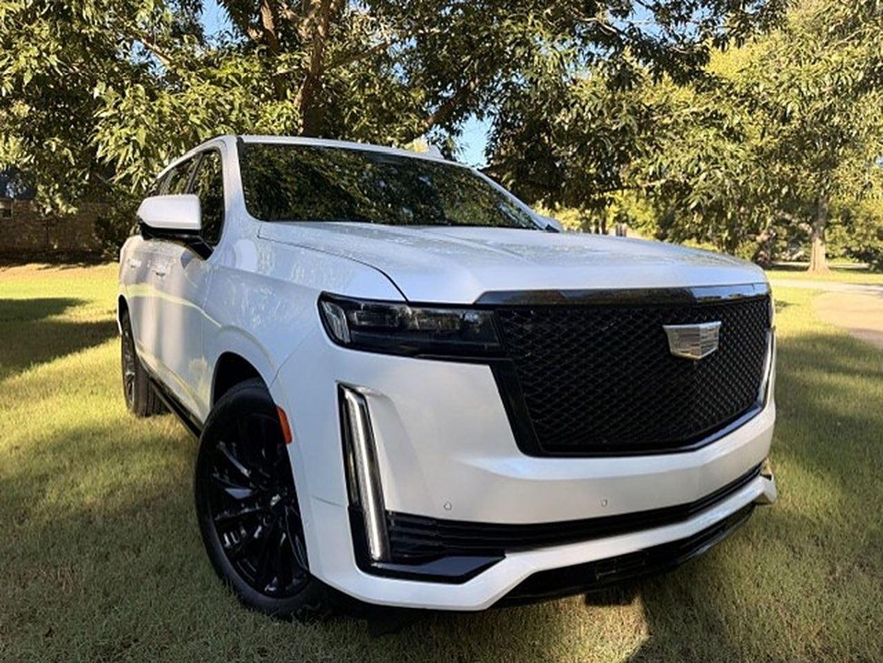 White Cadillac Escalade with black wheels, the newest vehicle in the Social Luxury Sprinter fleet in Tulsa