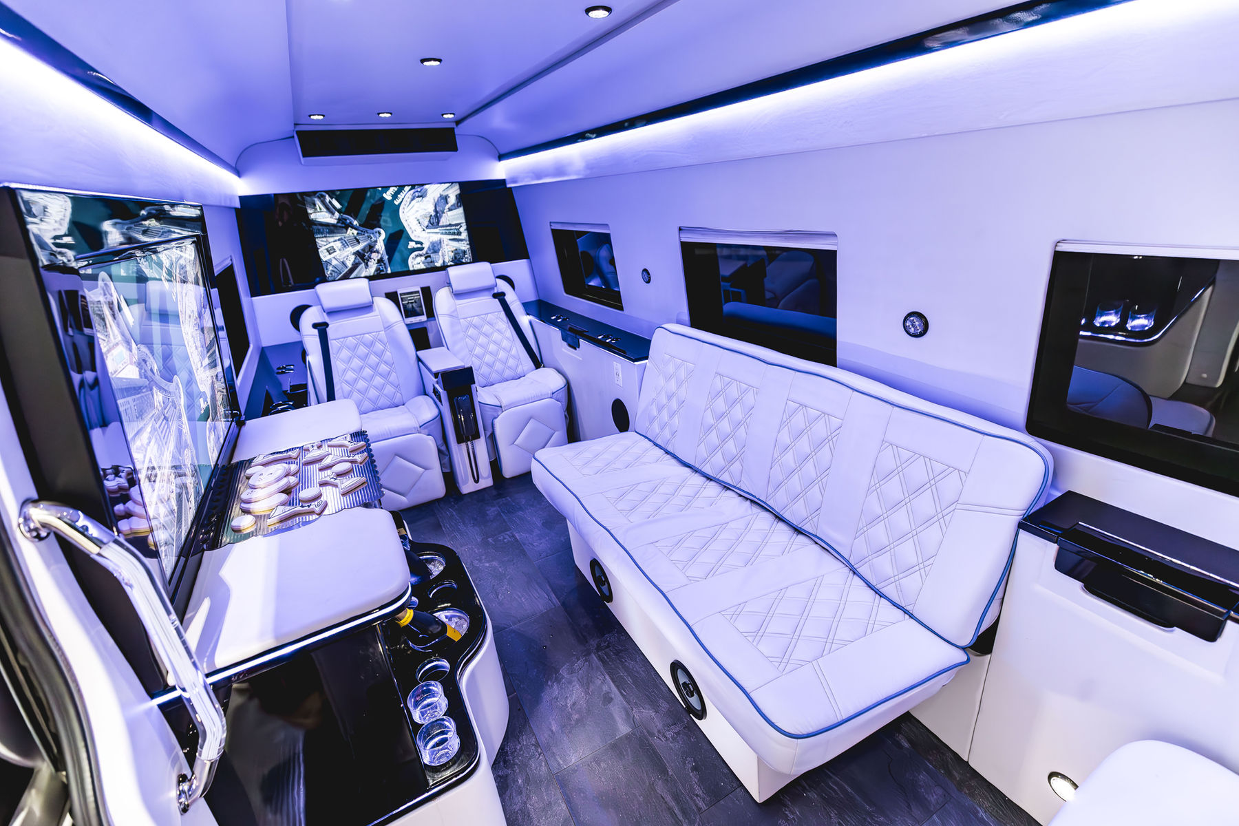 Lounge-style cabin of the luxury Mercedes Sprinter with ambient lighting