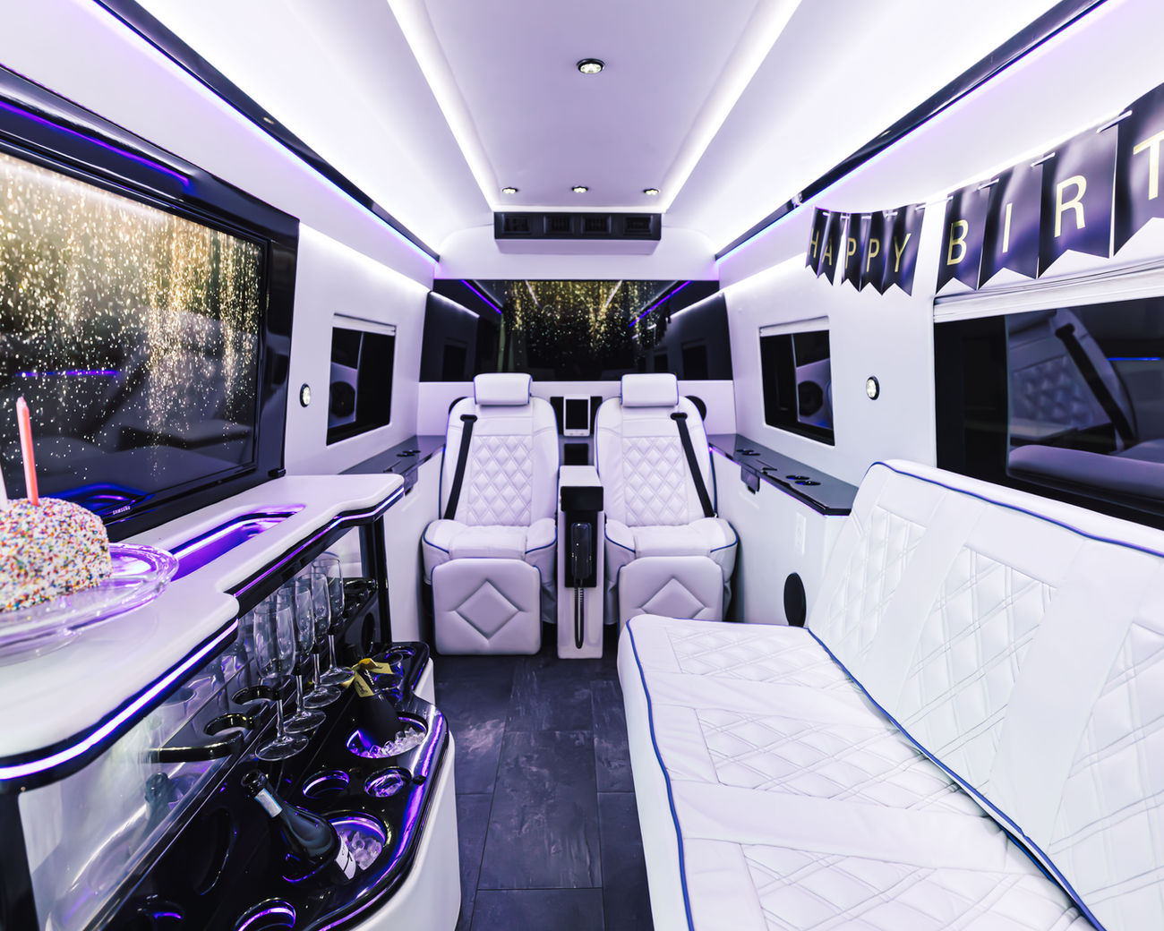 White diamond-stitched Italian leather interior with a marble bar and ambient lighting inside the luxury Sprinter